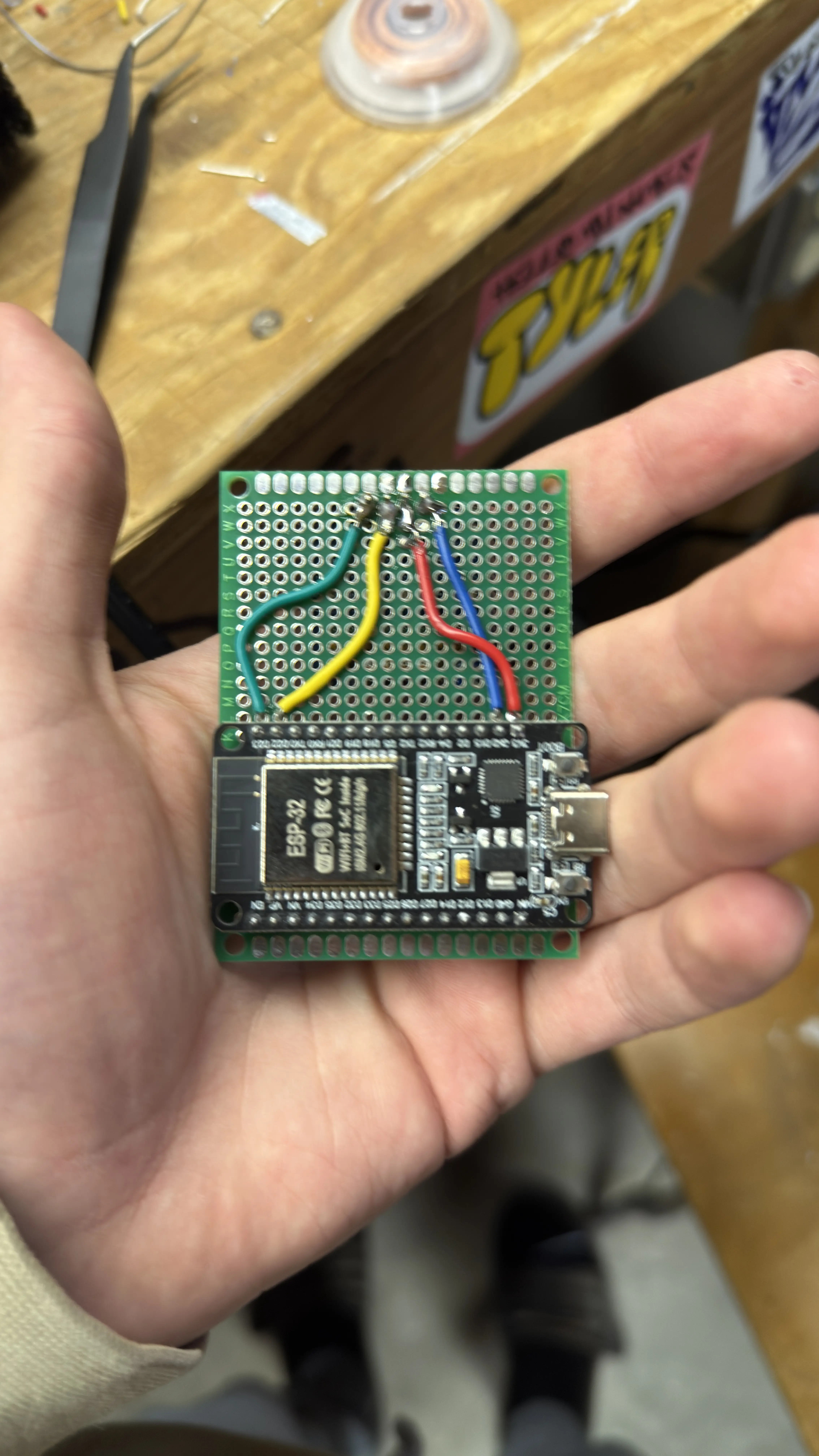 Back view of a perfboard showing soldered connections and wiring.